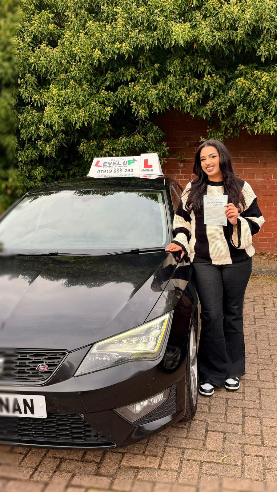 Successful student with driving instructor car